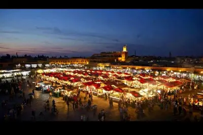 a crowd of people standing around a market at night at apartment 12 Marrakech centr gueliz in Marrakech