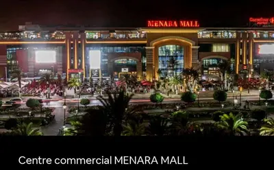 a large shopping mall at night with the words centre commercial mereka marina mall at apartment 12 Marrakech centr gueliz in Marrakech