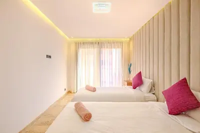 a hotel room with two beds with pink pillows at Large elegant 2BR Apt in Gueliz in Marrakech
