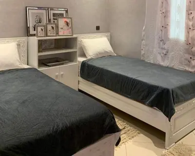 two beds sitting next to each other in a bedroom at well-equipped apartment in Marrakech
