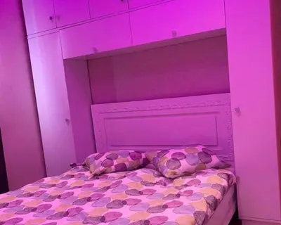 a bed with pink lights on top of it at well-equipped apartment in Marrakech