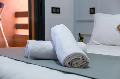 two rolls of towels sitting on a bed at Central Gueliz 2 min M Avenue Balcony Pool View in Marrakech