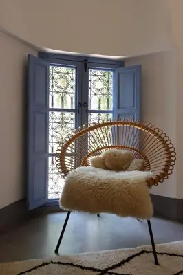 a chair with a furry cushion in front of a door at mon riad in Marrakech