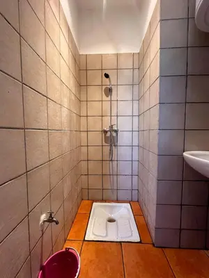 a bathroom with a shower with a toilet in the floor at Marrakech Oasis, Residence Ennaim 1 in Marrakech