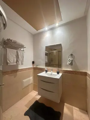 a bathroom with a sink and a mirror at Marrakech Oasis, Residence Ennaim 1 in Marrakech