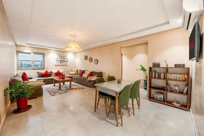 a living room with a couch and a table at Apartment center marrakech - Gueliz in Marrakech