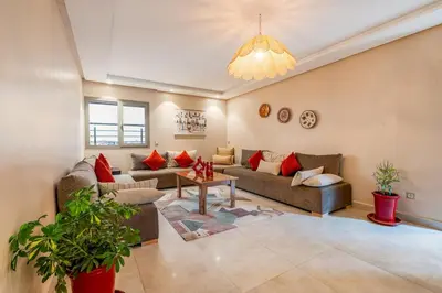a living room with couches and a chandelier at Apartment center marrakech - Gueliz in Marrakech