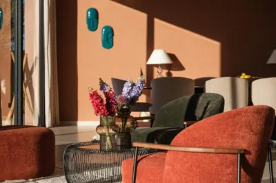 a lobby with chairs and a table with flowers on it at La Salea - Golf Amelkis in Marrakech
