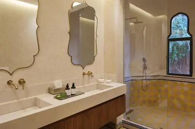 a bathroom with a tub and a sink and a shower at Villa Amelya - Amelkis Golf in Marrakech