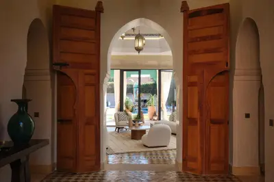 an archway leading into a room with a living room at Villa Amelya - Amelkis Golf in Marrakech