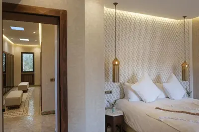 a bedroom with a king sized bed and a hallway at Villa Amelya - Amelkis Golf in Marrakech