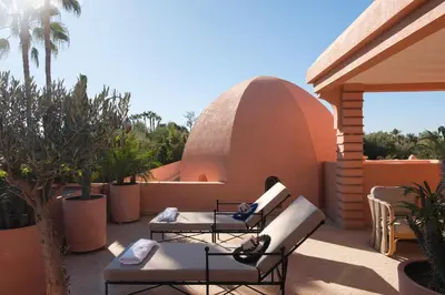 a patio with chairs and tables and a dome at Villa Amelya - Amelkis Golf in Marrakech