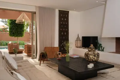 a living room with a couch and a table at Villa Ty Habibi - Super 5 Bedroom with Private Heated Pool by the Golf Amelkis in Marrakech