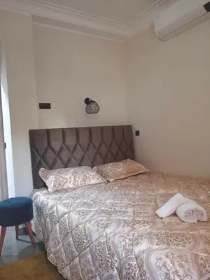 a bedroom with a bed with two towels on it at Airport Menara Appartment in Marrakech