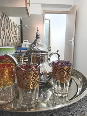a tray with glasses and a tea pot on a counter at Airport Menara Appartment in Marrakech