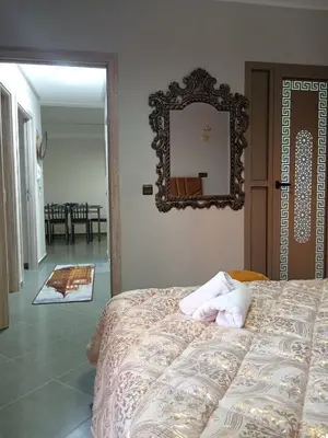a bedroom with a bed and a mirror on the wall at Airport Menara Appartment in Marrakech