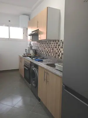 a kitchen with a stove and a dishwasher at Airport Menara Appartment in Marrakech