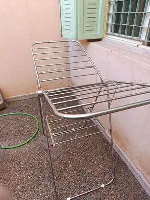a metal chair next to a window with a hose at Marrakech welcome in Marrakech