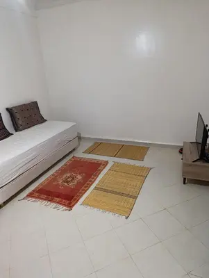 a living room with three rugs on the floor at Marrakech welcome in Marrakech