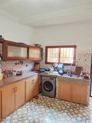 a kitchen with a sink and a washing machine at Relaxing Family Home outside Marrakech in Marrakech