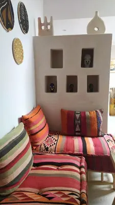 a living room with colorful pillows and a couch at Riad rooftop, pool and stunning view in Marrakech