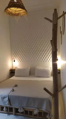 a bed in a room with a large headboard at Riad rooftop, pool and stunning view in Marrakech