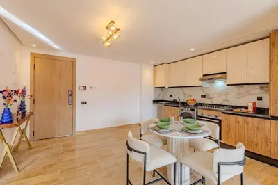 a kitchen with a table and chairs in a room at Elegant 2BR apartment in Gueliz in Marrakech