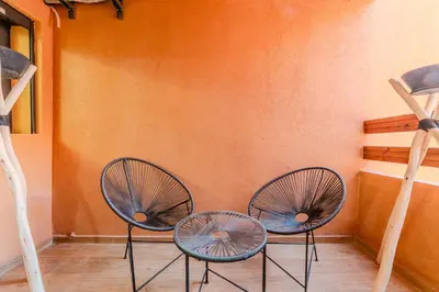 a couple of chairs sitting next to a wall at New! Apartment Gueliz 2 min M Avenue with Pool and 24h Security & Parking in Marrakech