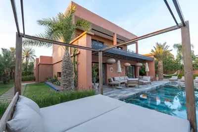 a house with a swimming pool in front of a house at Villa luxe Dar Paumar, Marrakech in Marrakech