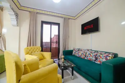 a living room with a green couch and two chairs at Family Apartment in Marrakech 3 Bedrooms & Balcony with View in Marrakech