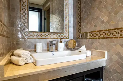 a bathroom with a sink and a mirror at Riad N5 in Marrakech