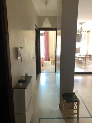 a living room with a table and a couch at Superb Location in Marrakech in Marrakech
