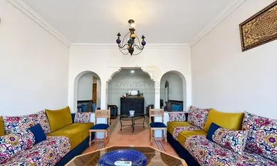 a living room with couches and a table at Appartement charmant à Guéliz in Marrakech