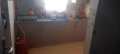 a kitchen with a sink and a stove and a window at المغرب in Marrakech