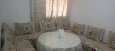 a room with a table with pillows and a window at المغرب in Marrakech