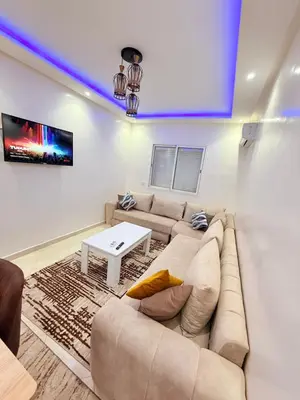 a living room with a couch and a table at Appart N35 COSY CONFORT FAMILY in Marrakech