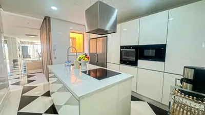 a kitchen with white cabinets and a counter top at Appartement PRESTIGIA MARRAKECH VILLAGE in Marrakech