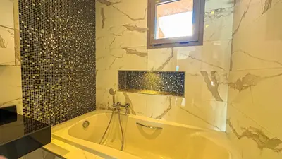a bath tub in a bathroom with a window and a window at Appartement PRESTIGIA MARRAKECH VILLAGE in Marrakech