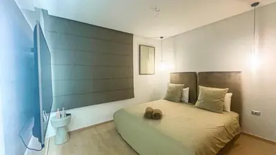 a bedroom with a bed with two shoes on it at Appartement PRESTIGIA MARRAKECH VILLAGE in Marrakech