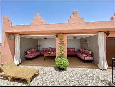 a patio with pink couches and a table at Terrace Room with Atlas View in Marrakech