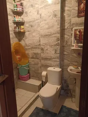 a bathroom with a toilet and a sink at Mhamid10, Albahja Route Agafay in Soltane