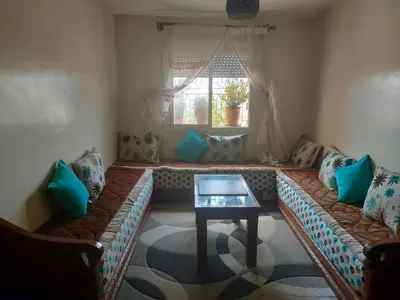 a living room with a couch and a table at Mhamid10, Albahja Route Agafay in Soltane