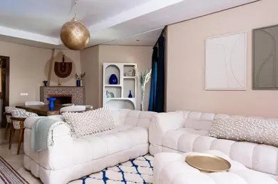 a living room with two white couches and a table at Zellige Suite - Gouvernante et piscine ! in Marrakech
