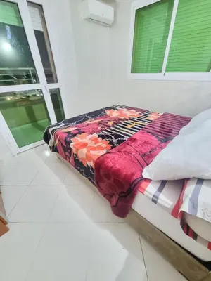 a bed with a colorful blanket on it in a room at Relaxing Stay Close to Everyting in Marrakech