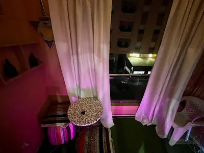 a room with a window with pink curtains at appartement guliz in Marrakech