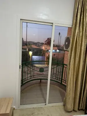 a sliding glass door with a view of a balcony at Le Central Hivernage 8-37-44 face gare CTM et a 10mn de l'aéroport in Marrakech