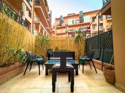 a patio with a table and chairs on a balcony at Majorelle Apartment 1- Bedroom 1-Terrace Centre in Marrakech