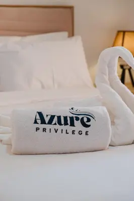 a pile of towels sitting on top of a bed at 1BR Appart 2 min de M Avenue , Pool , Balcony & Parking & 24h j7 security in Marrakech