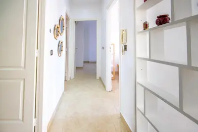 a hallway with white walls and a tile floor at La Menara - 2 Chambres - Centre - Wifi in Marrakech