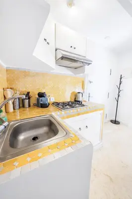 a kitchen with a sink and a stove top oven at Luxe Studio 2min Carre Eden in Marrakech